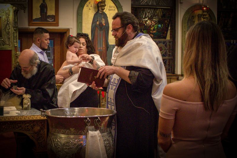 Christening day — the ceremony at the font
