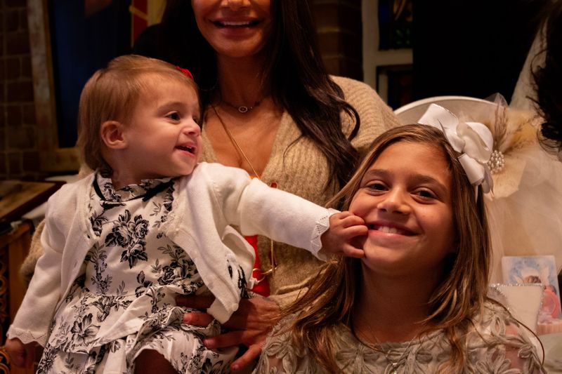 Christening day — sisters smiling