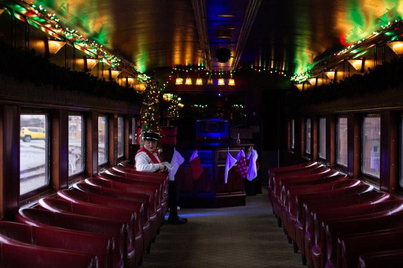 Inside a train car dressed in Christmas lights